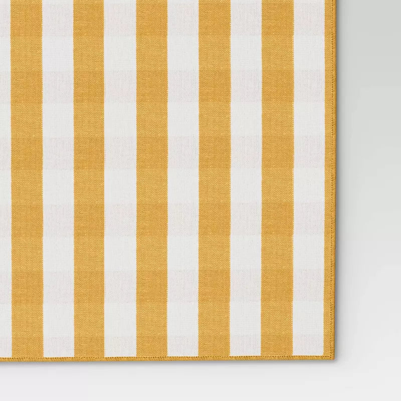 Striped fabric with yellow and white vertical stripes on a gray background