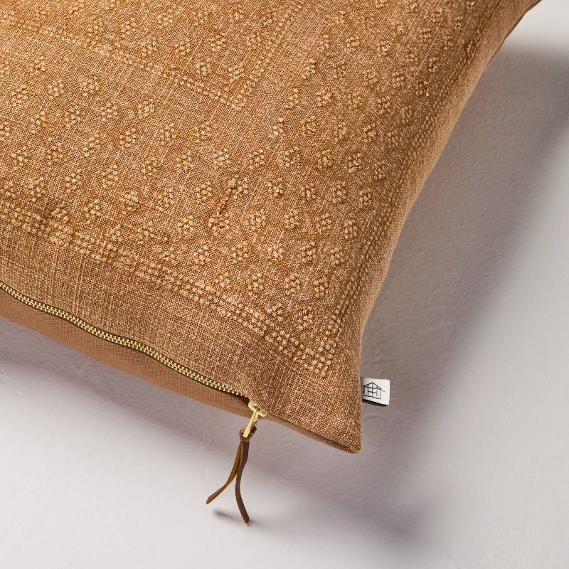 Brown textured pillow with a zipper on a light gray background Natural