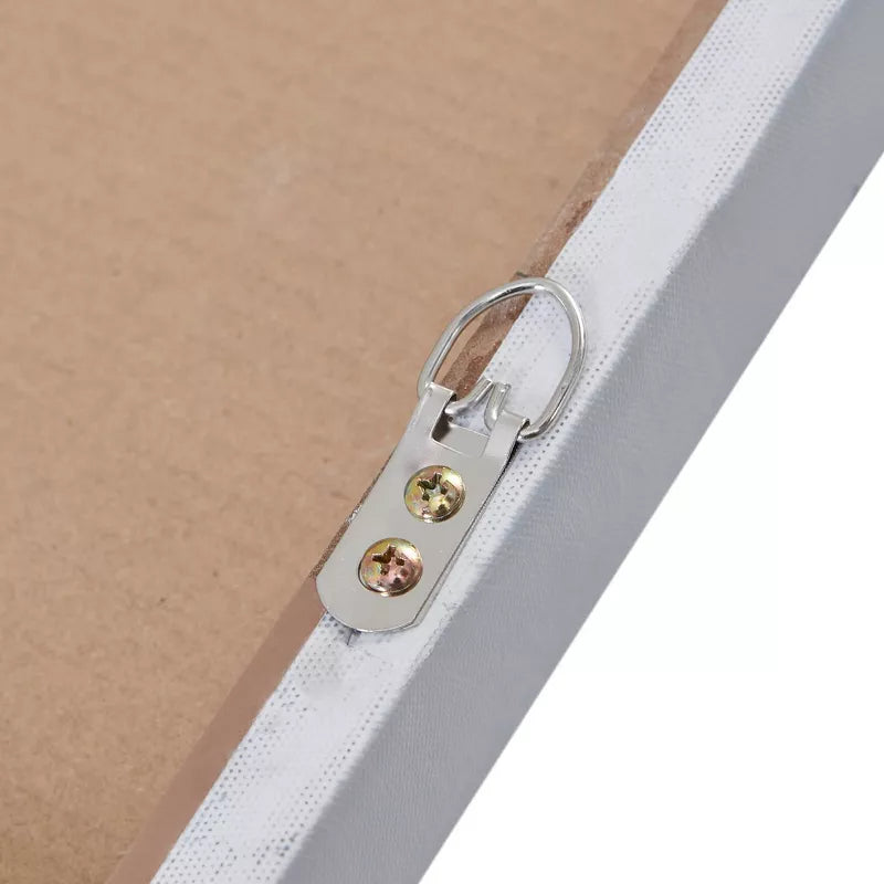 Close-up of a metal clip with colored stones on a white surface.