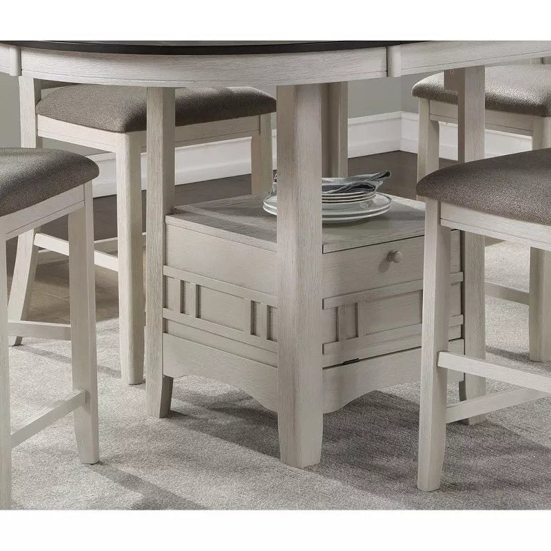 Dining table with chairs and a small cabinet underneath on a gray carpet.