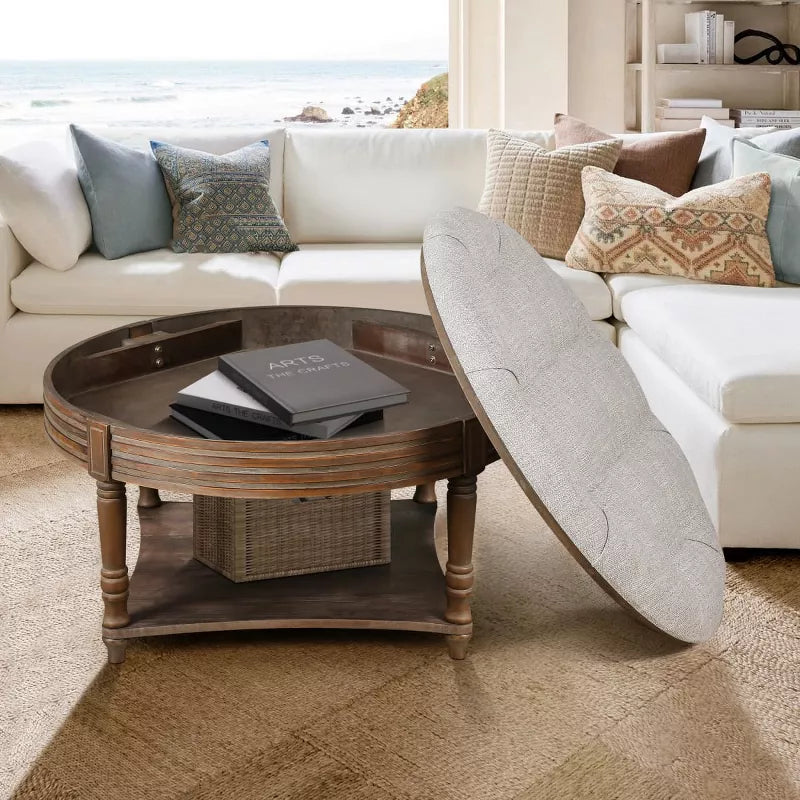 Round wooden coffee table with a gray cushion in a living room setting. gray