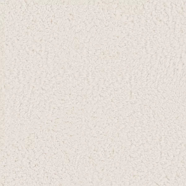 A round, cream colored ottoman with a textured surface and a gold colored base."