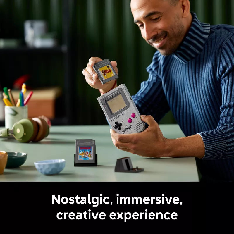 Man playing with a handheld gaming device in a casual setting