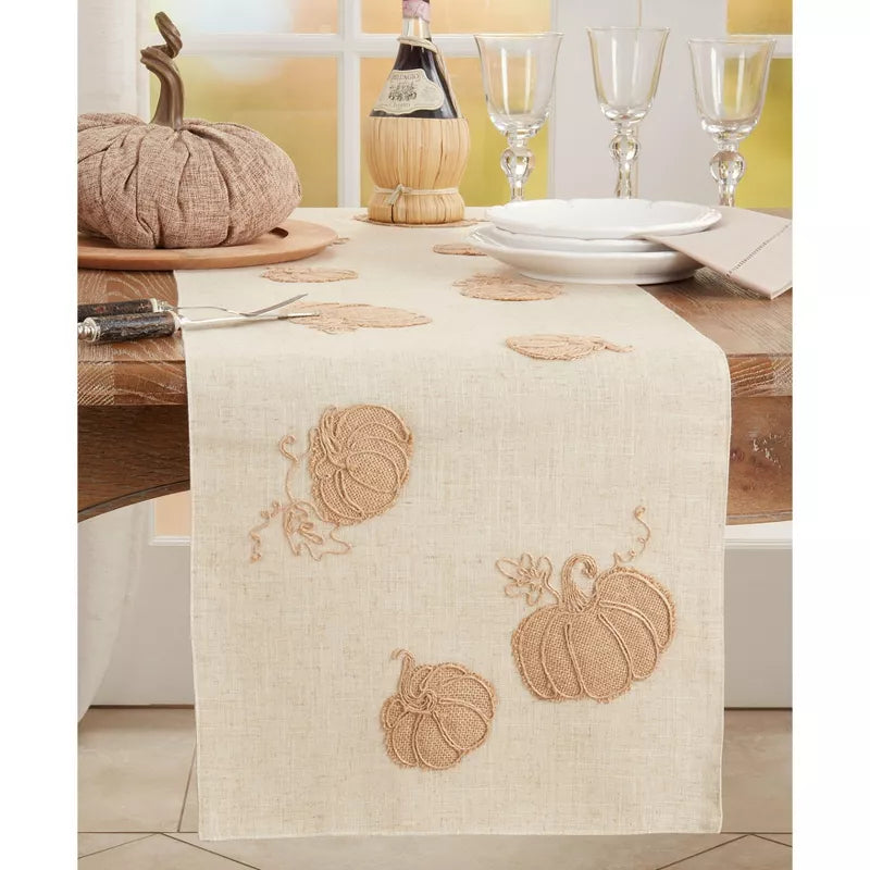Table runner with pumpkin design on a dining table setting