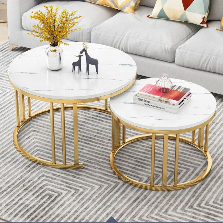 Set of two round marble coffee tables with gold metal frames in a living room Gold White