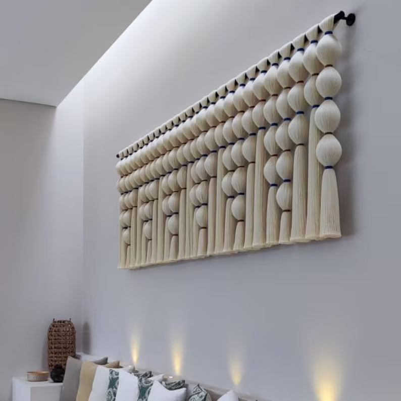 Decorative wall art with spherical elements on a plain wall.