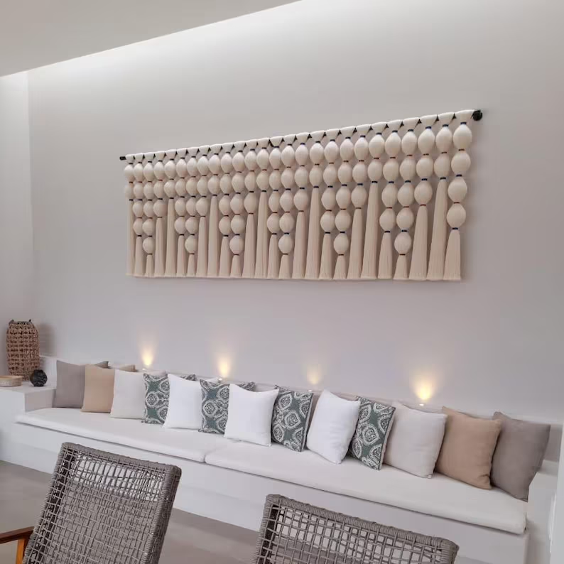 Modern living room with a decorative wall art piece above a sofa.