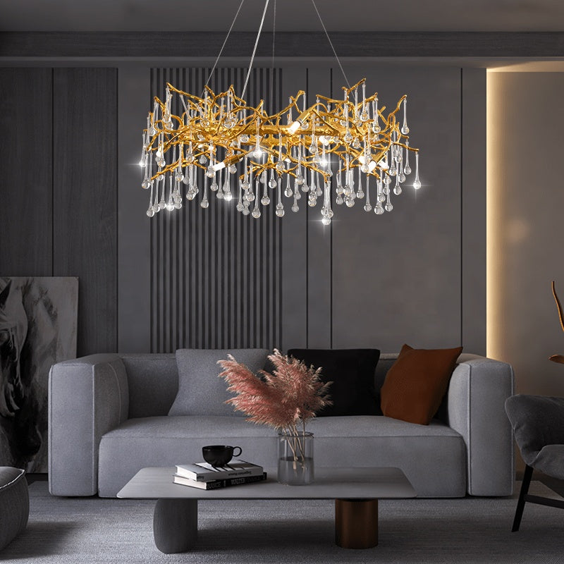 Modern living room with a gold chandelier, gray sofa, and coffee table.
