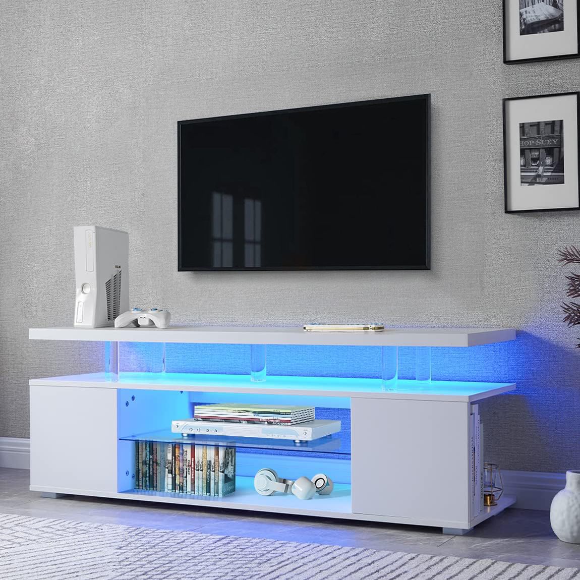 Modern living room with a TV mounted on the wall and a white entertainment console with blue LED lighting.
