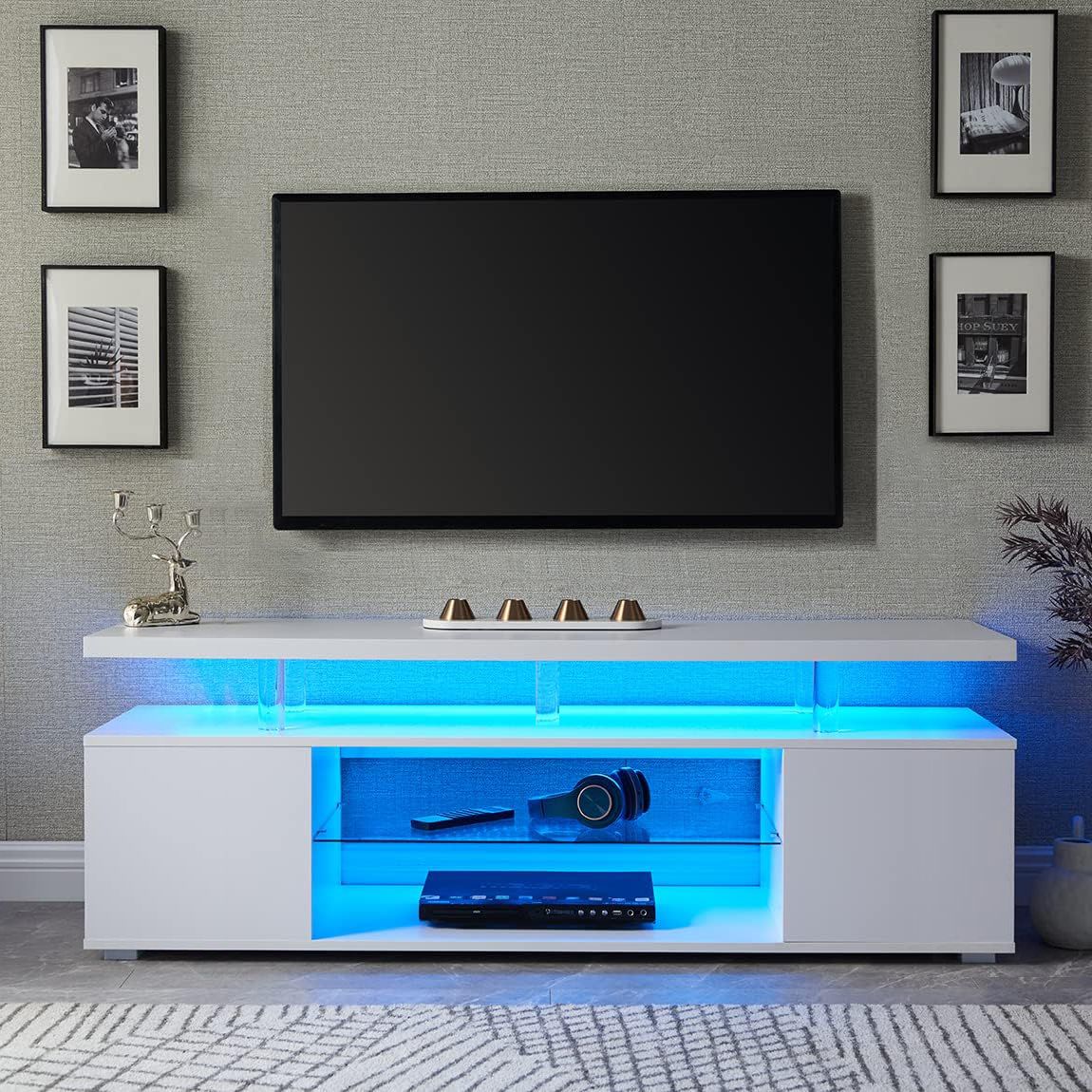 Modern living room with a TV mounted on the wall above a white entertainment console with blue LED lighting.