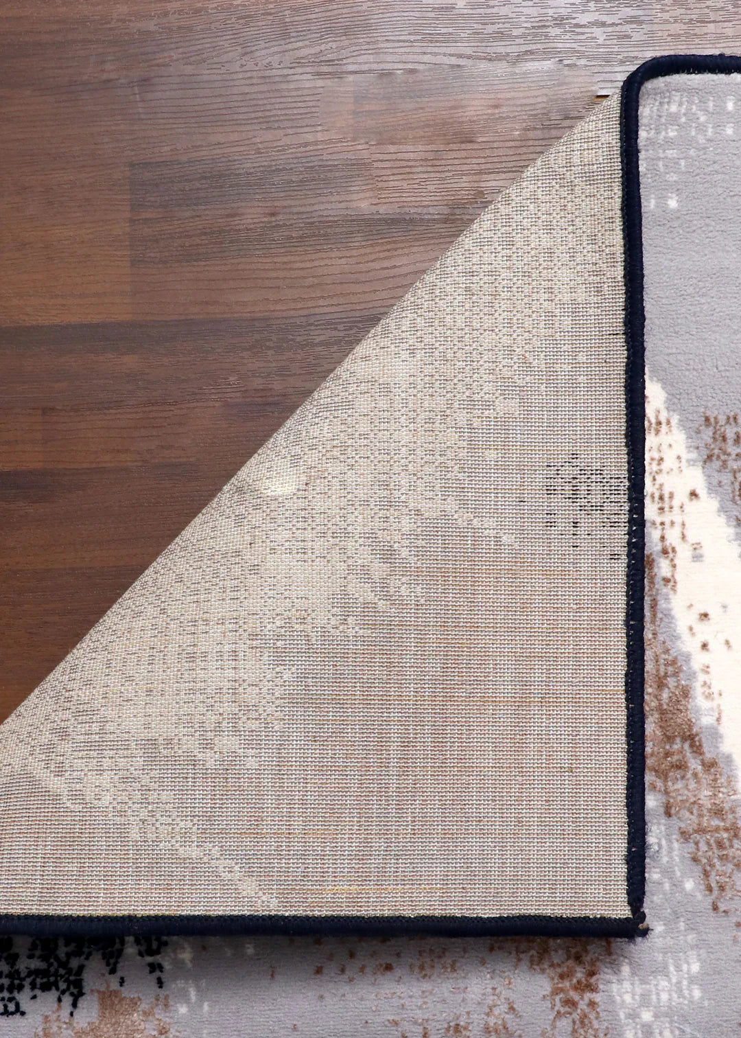 Abstract art print with black, white, and beige colors on a wooden surface