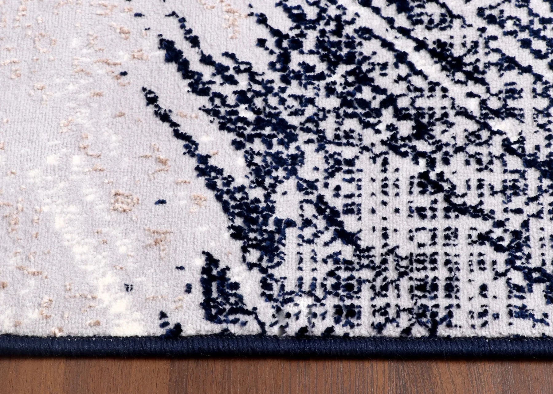 Abstract art print with black, white, and beige colors on a wooden surface
