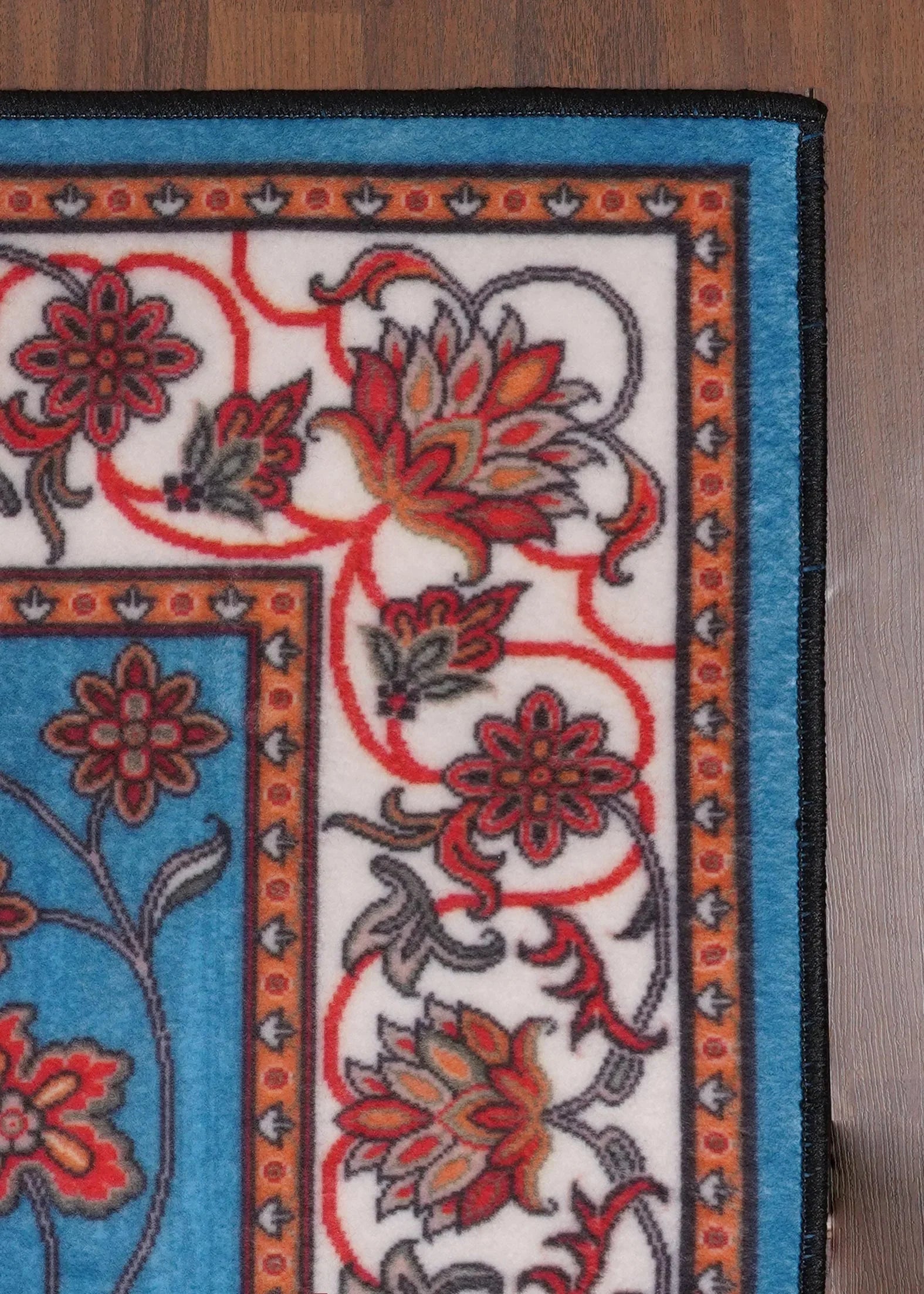 Decorative rug with floral patterns on a wooden floor