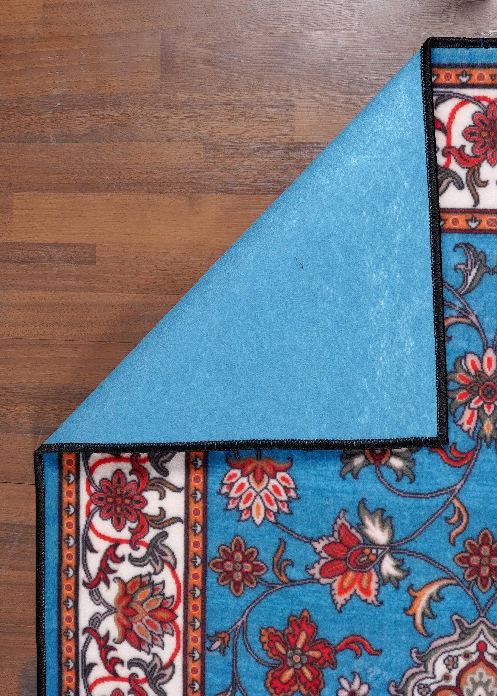 Decorative rug with floral patterns on a wooden floor