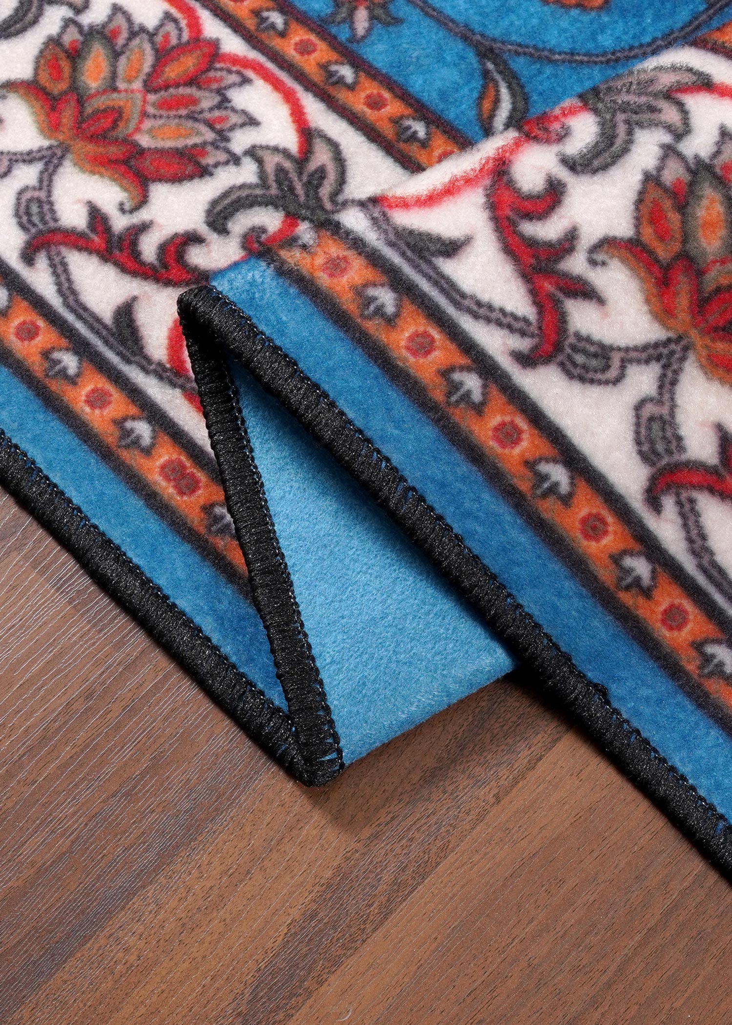Decorative rug with floral patterns on a wooden floor