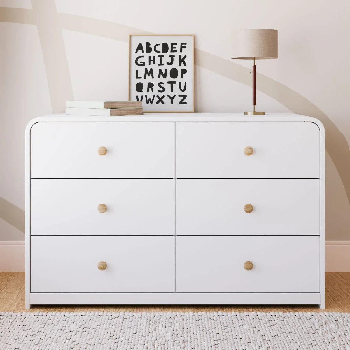 A modern 6-drawer dresser in white with small round gold knobs, shown against a clean white background.