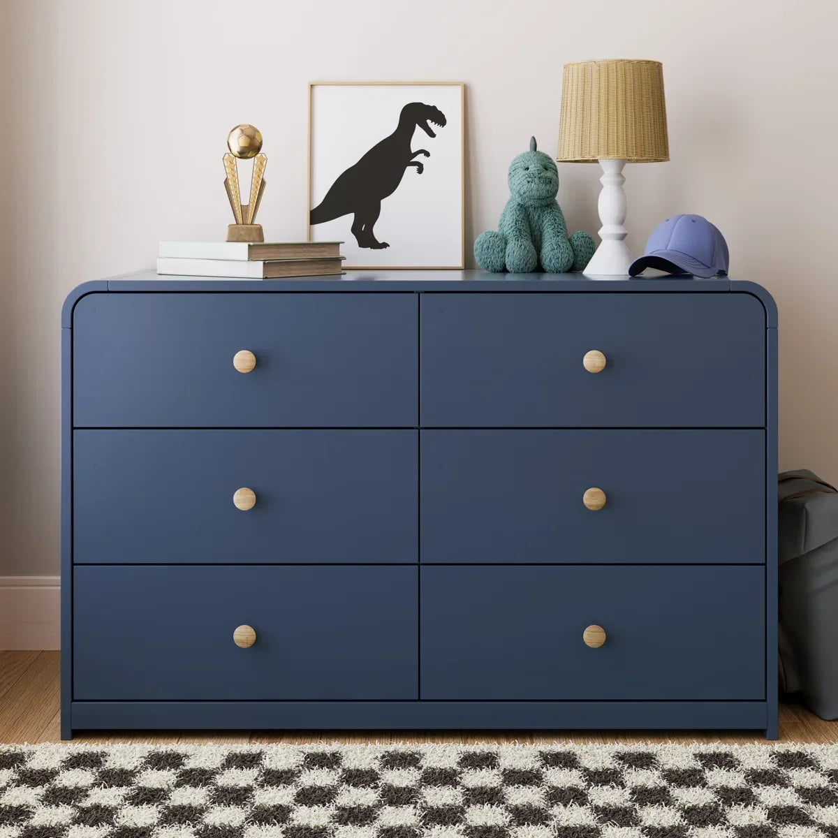 A navy blue 6-drawer dresser with light wood knobs, featuring one open drawer showing a light wood interior, set against a plain off-white background Midnight Blue