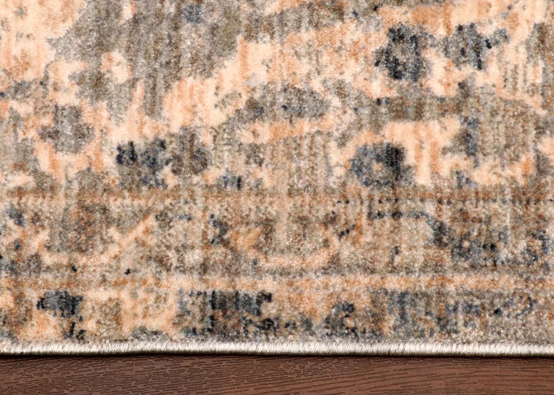 Patterned rug on a wooden floor