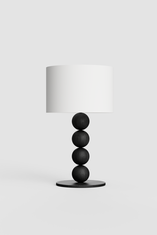 Table lamp with a white shade and black cylindrical base on a light gray background