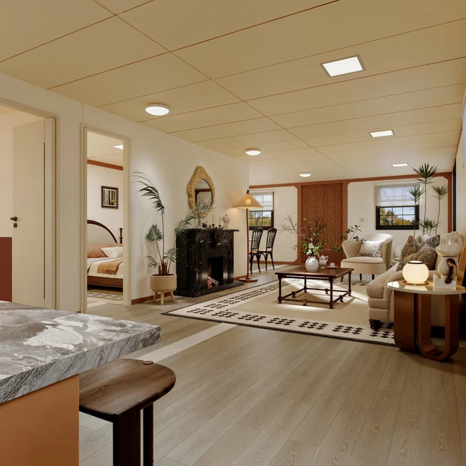 A modern, open-plan residential interior showing a living room with a fireplace, dining area, bedroom, and kitchen island, featuring light wood flooring, beige walls, and contemporary furnishings.