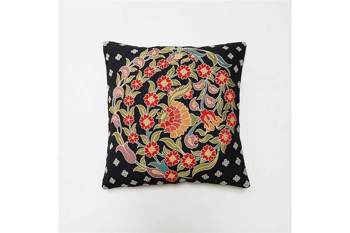 Decorative pillow with floral pattern on a black background