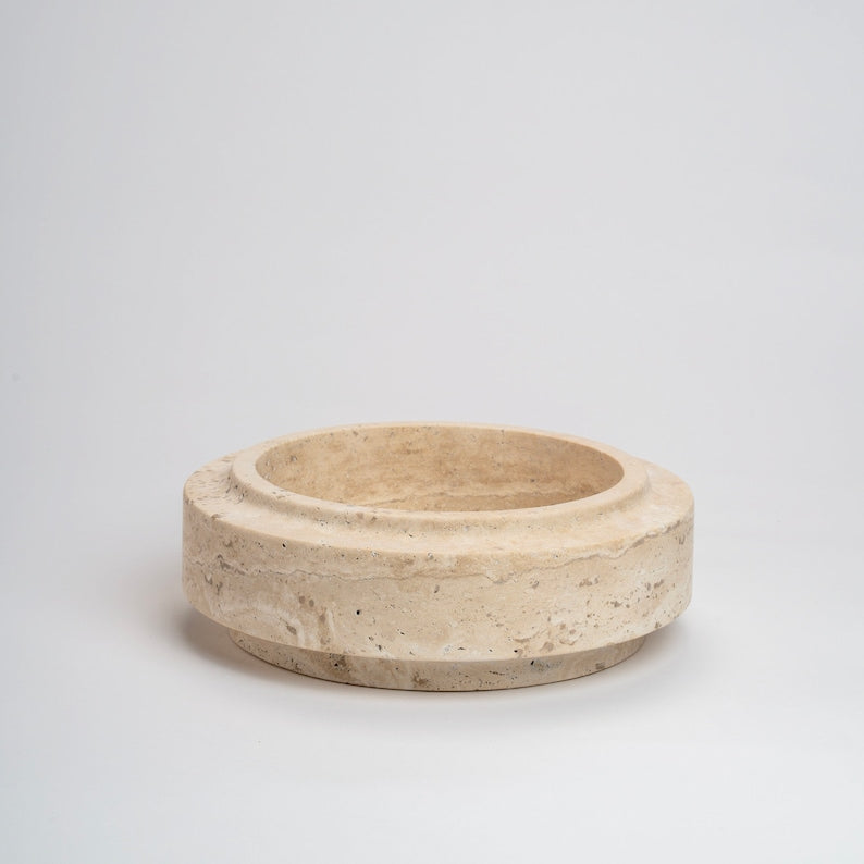 Beige stone bowl on a light gray background