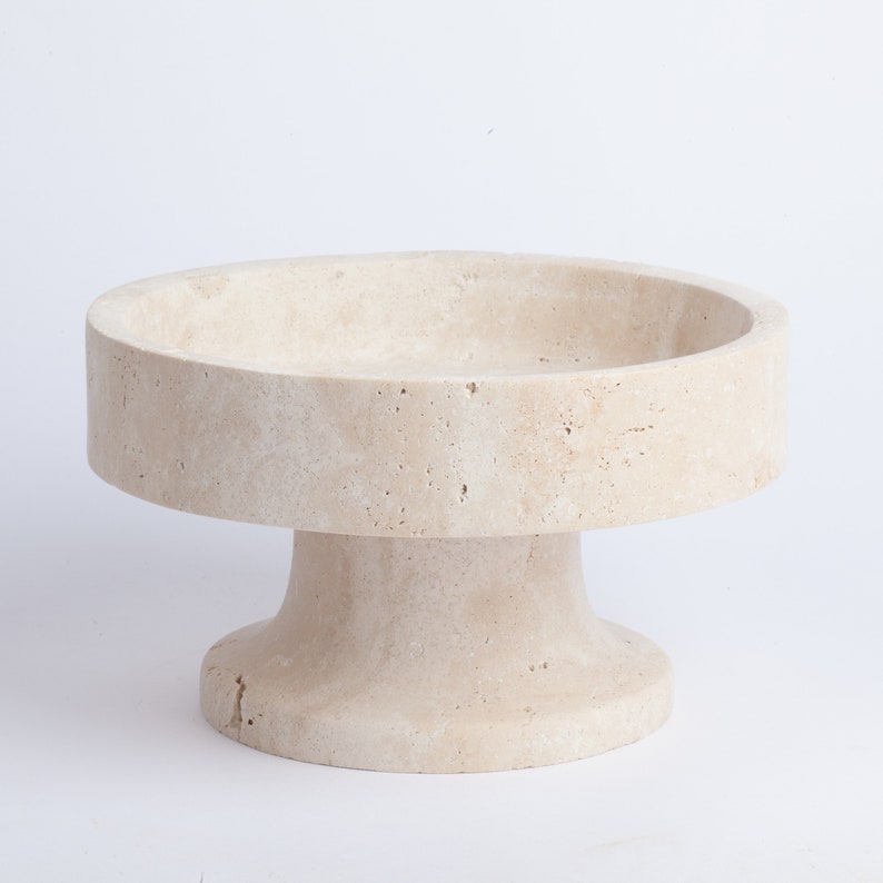 Beige stone pedestal on a white background