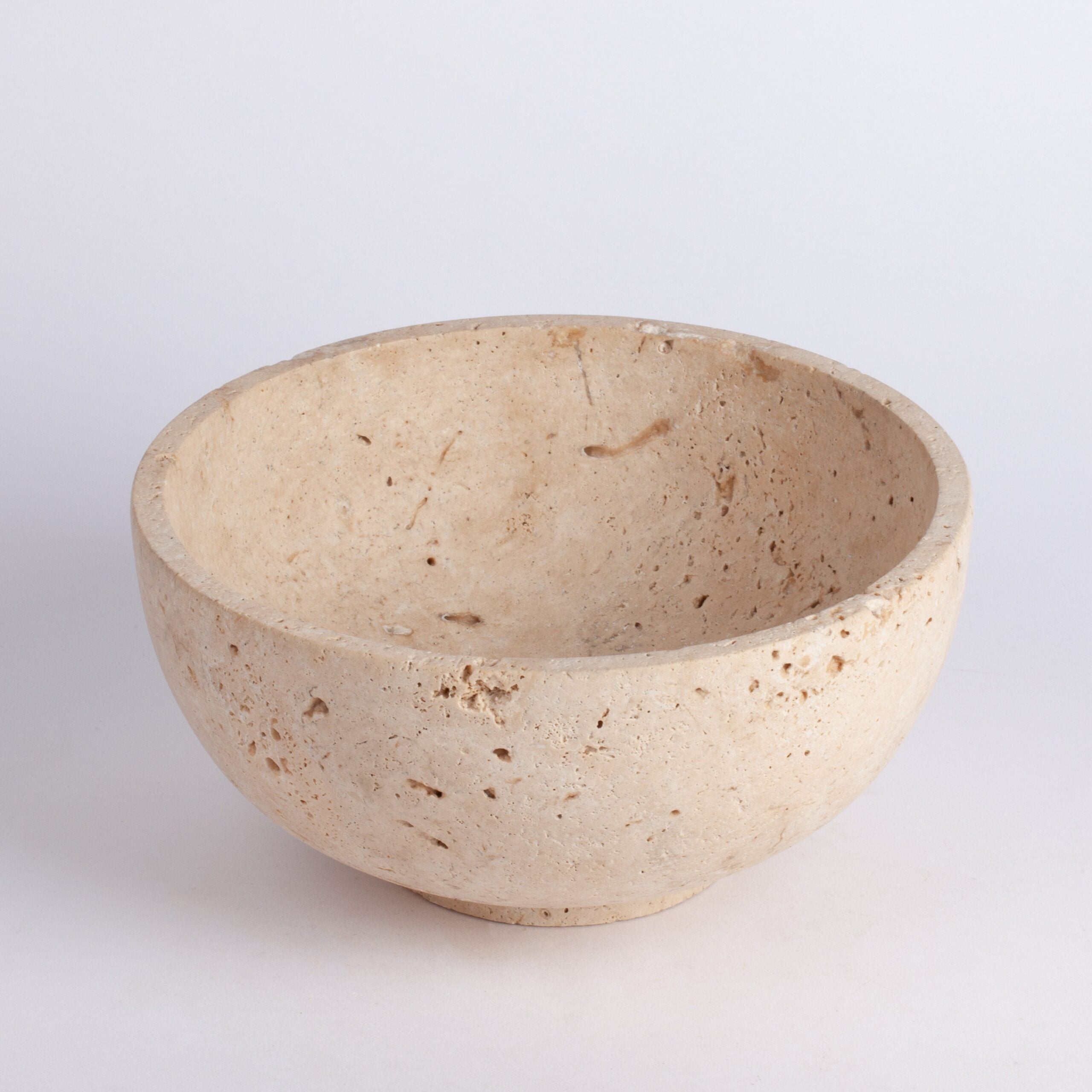 Beige ceramic bowl on a light gray background