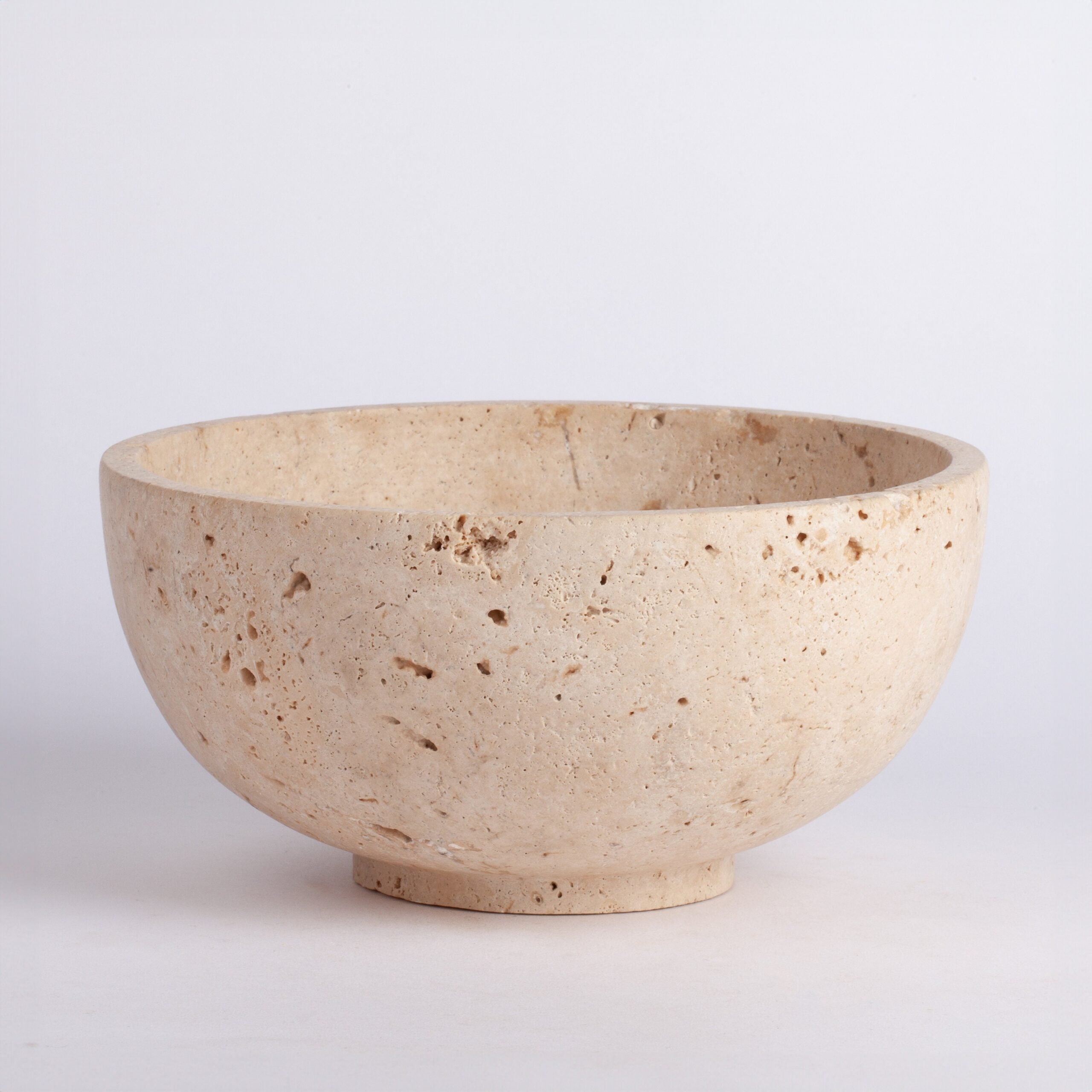 Beige ceramic bowl on a light gray background