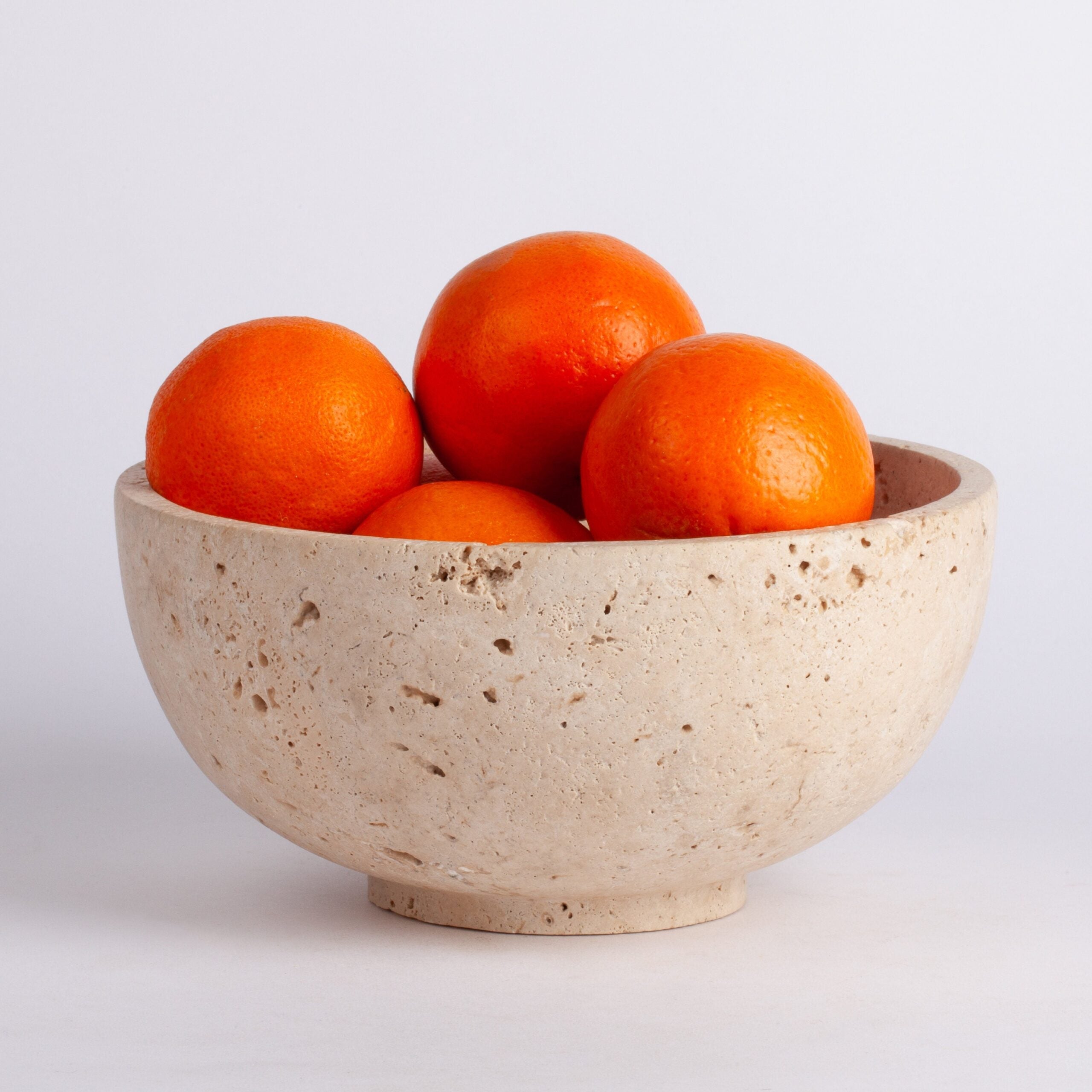 Beige ceramic bowl on a light gray background