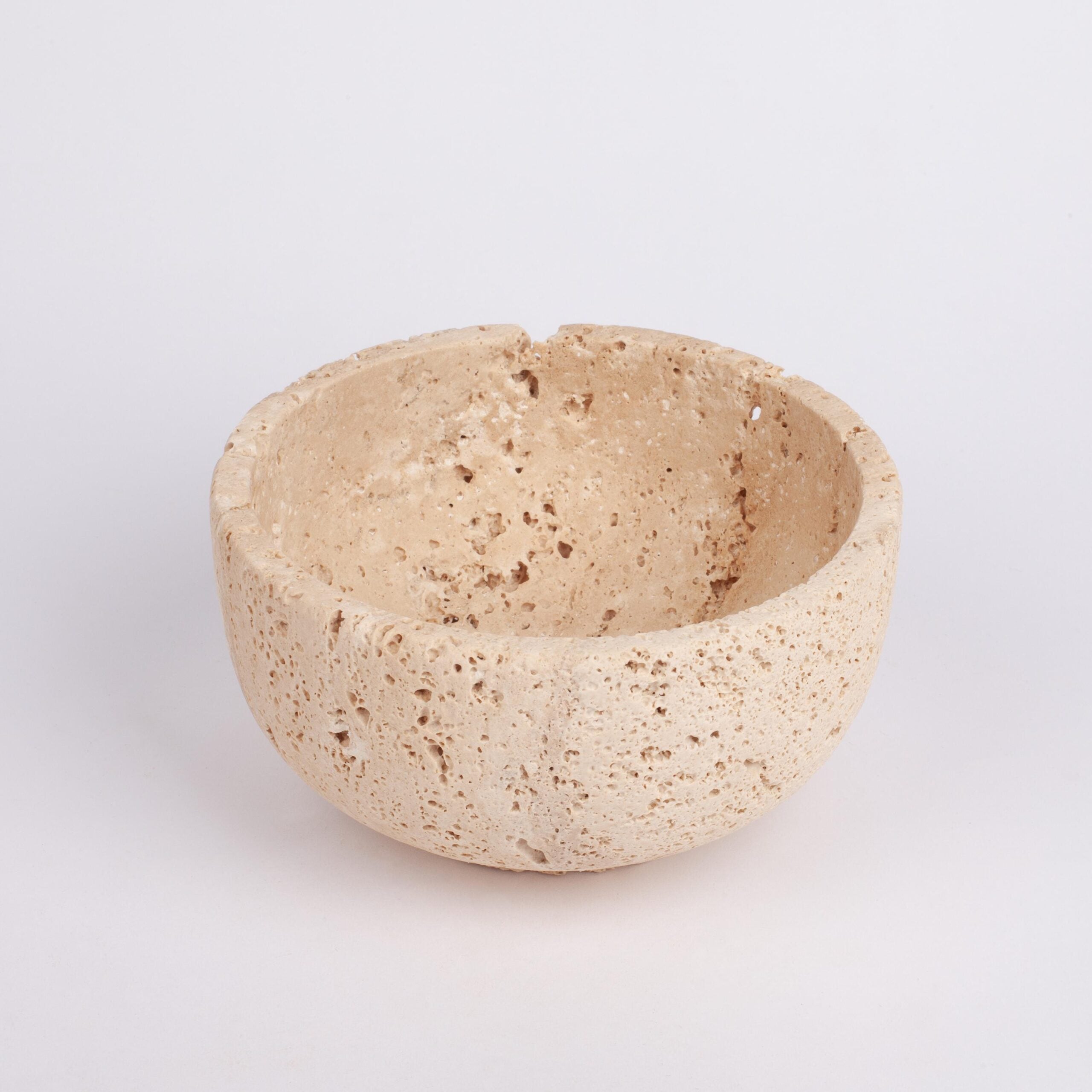 Beige stone bowl on a light gray background