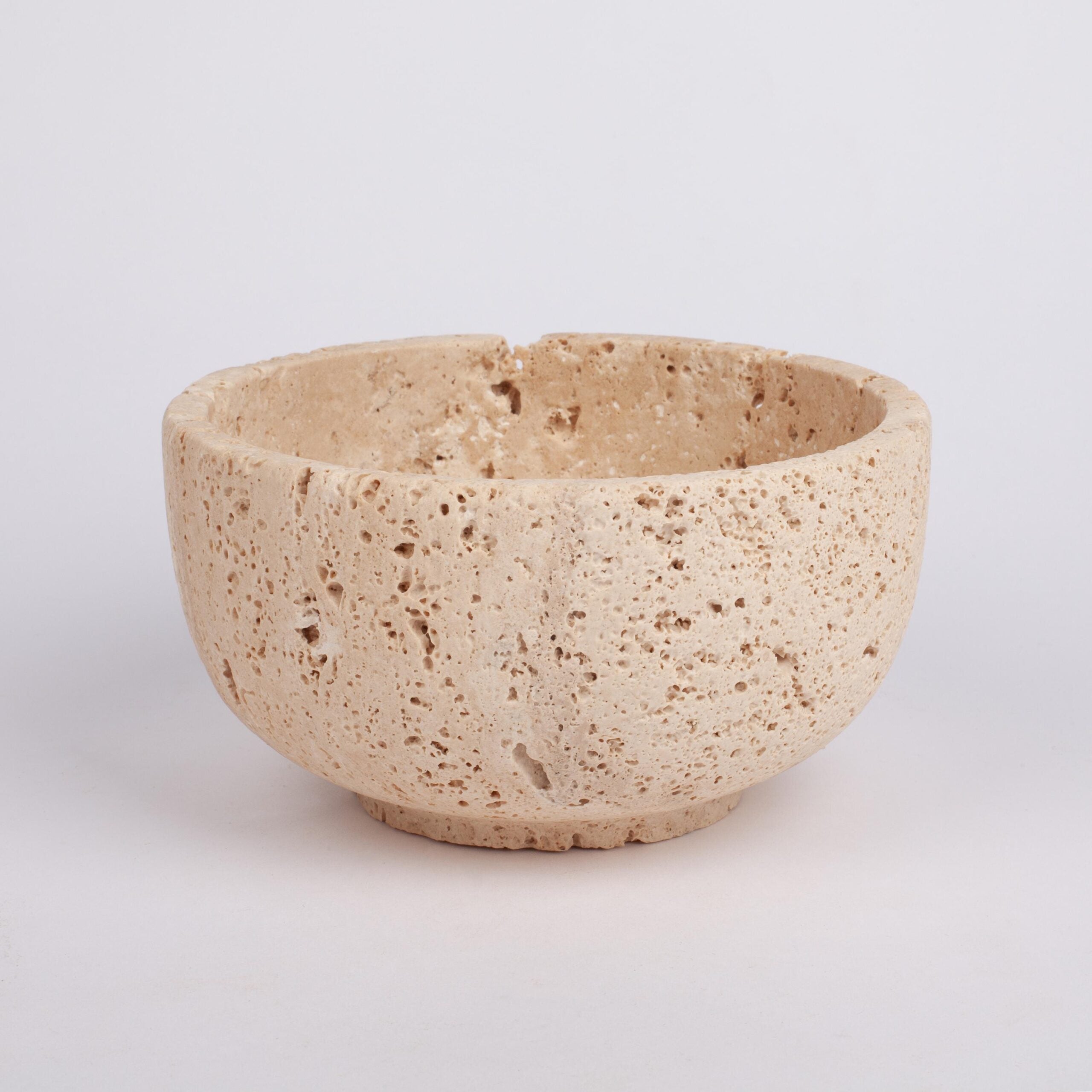 Beige ceramic bowl on a light gray background