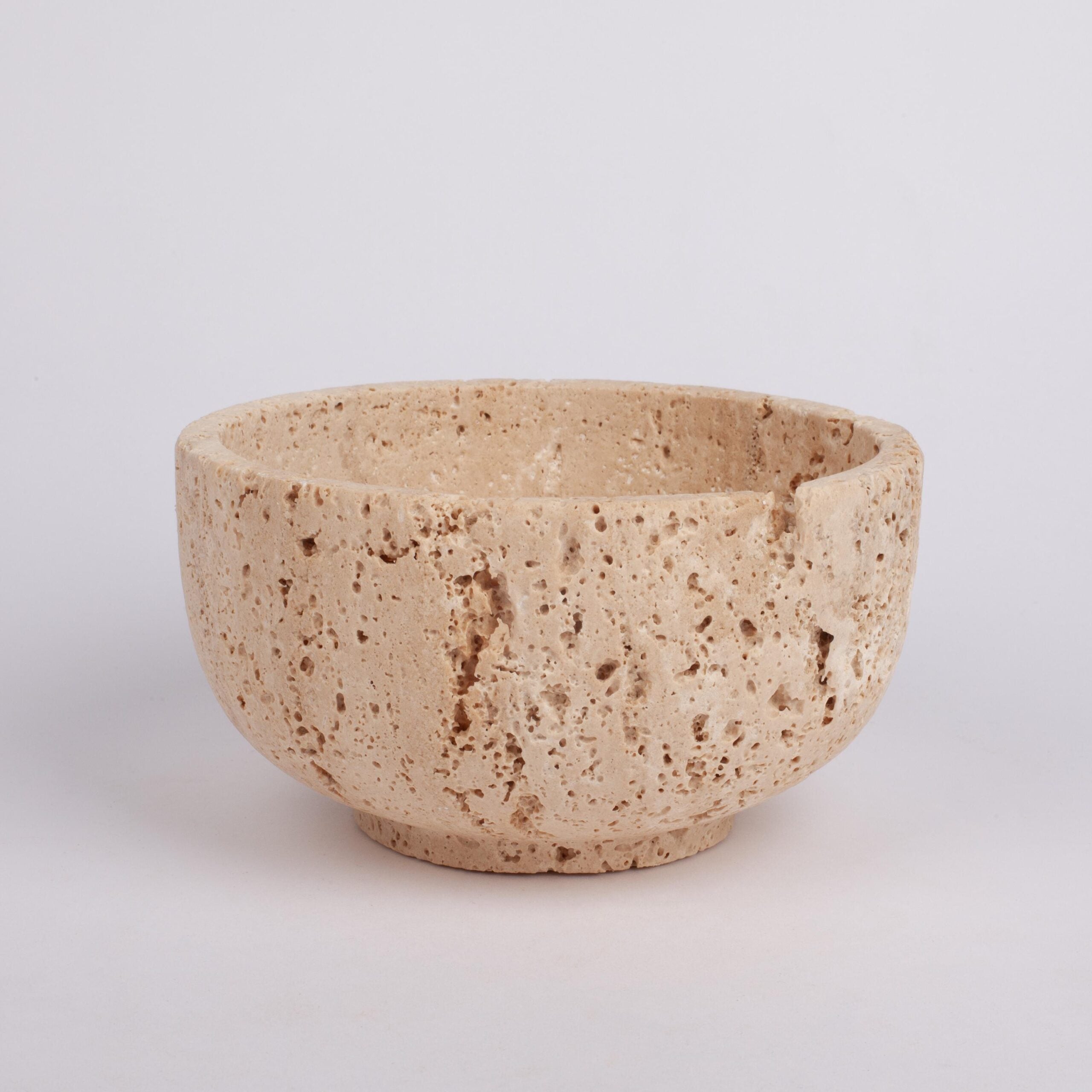 Beige ceramic bowl on a light gray background