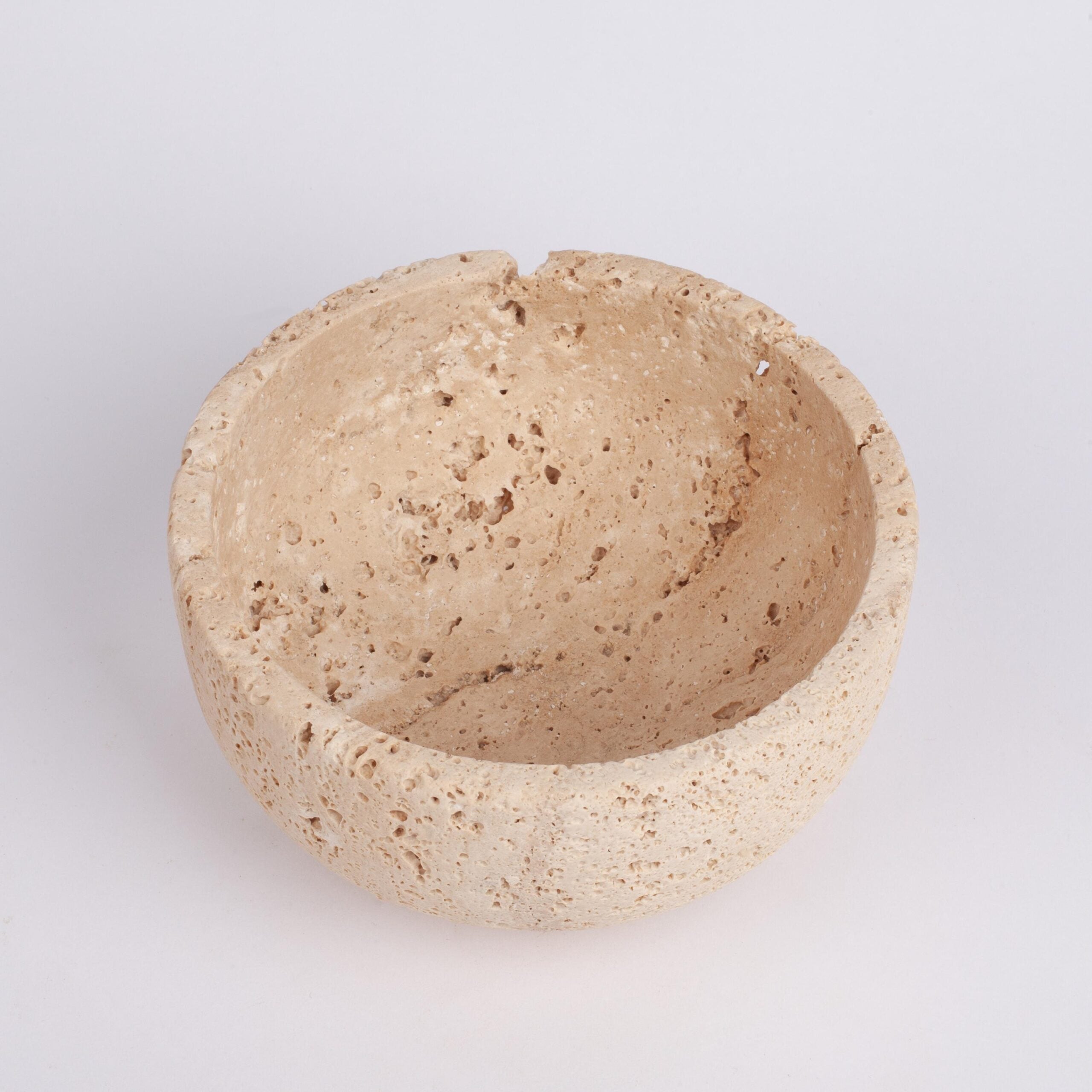 Beige stone bowl on a light gray background