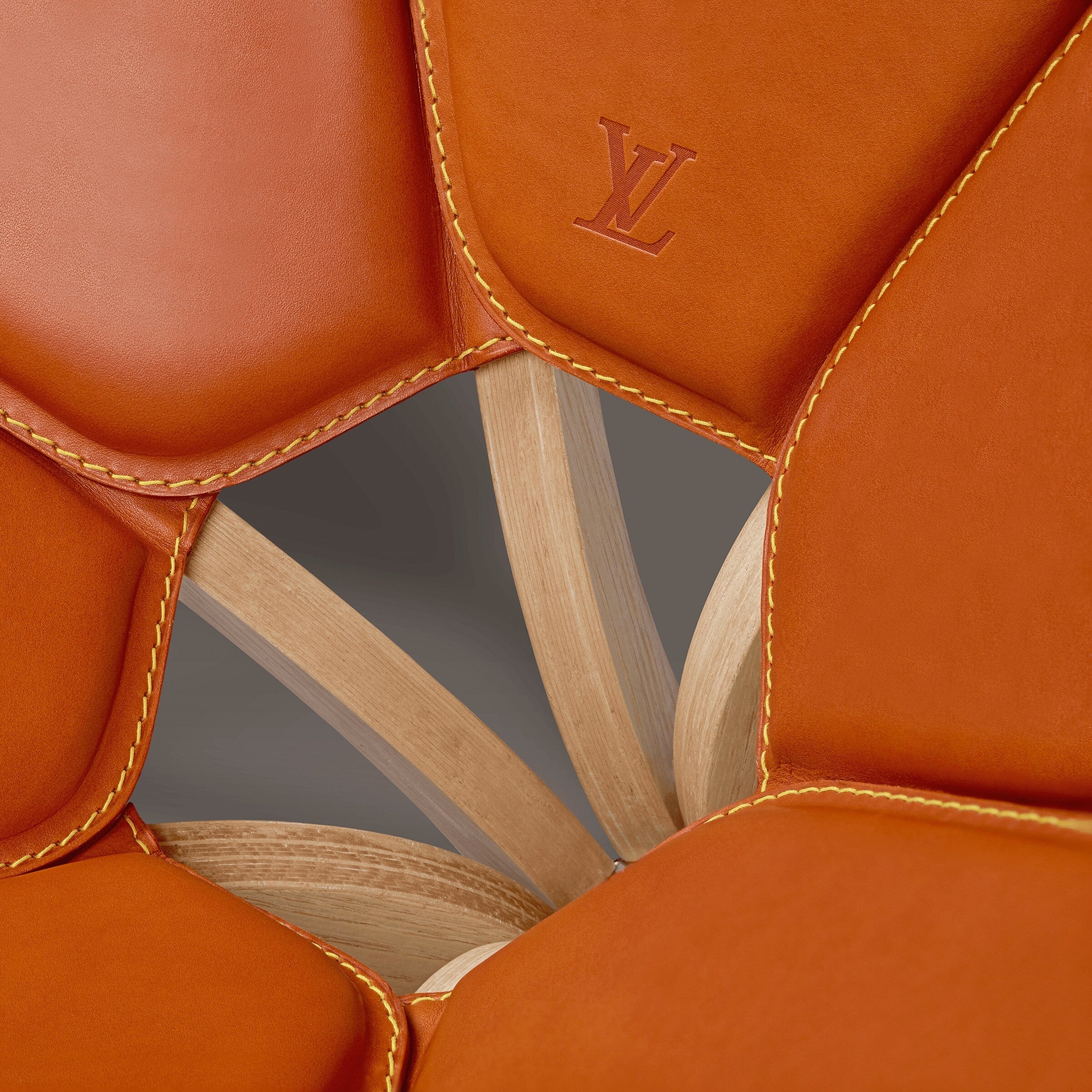Orange chair with wooden legs on a white background Caramel