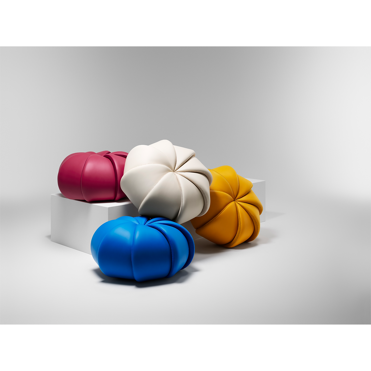 Three colorful kitchen molds in yellow, blue, and red on a light gray background Saffron