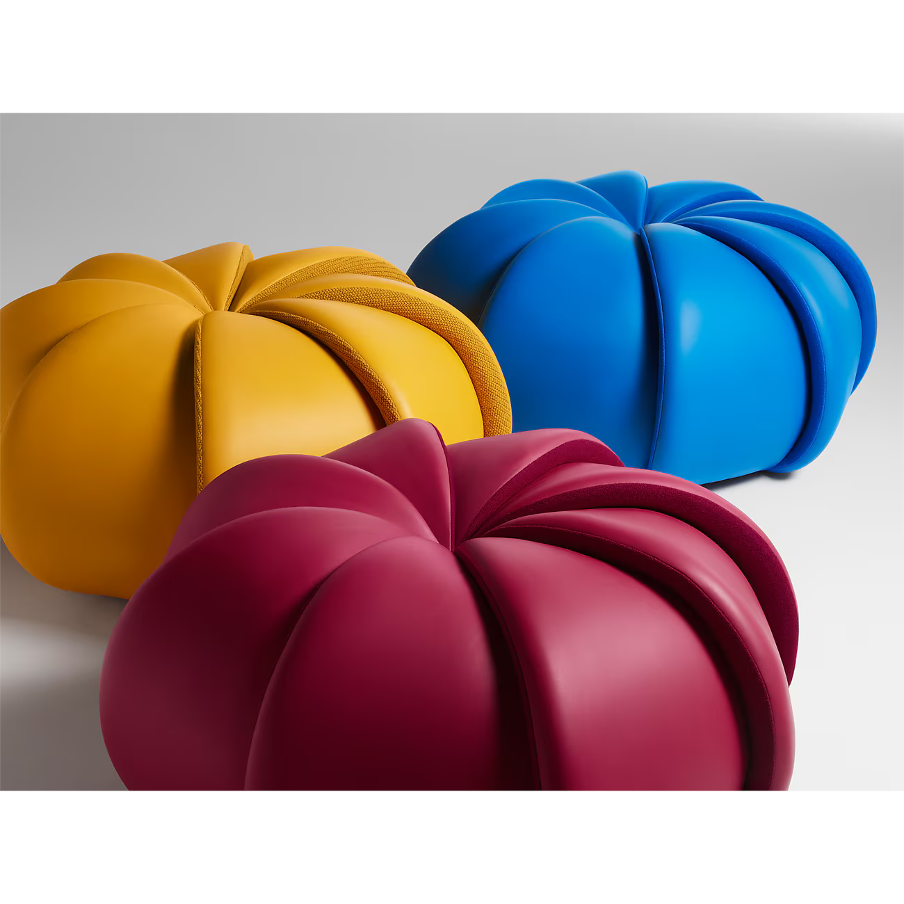 Three colorful kitchen molds in yellow, blue, and red on a light gray background Saffron