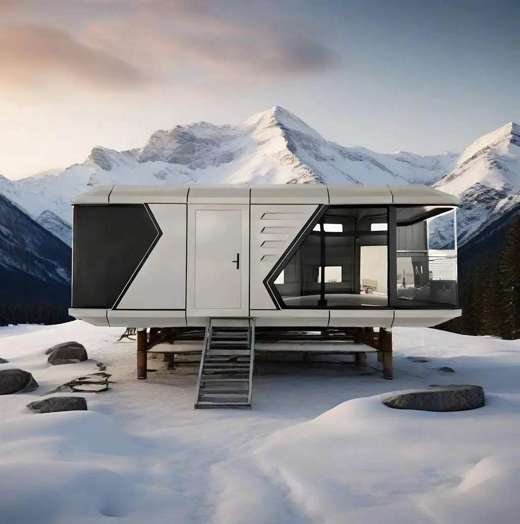 A modern white and black elevated cabin with large glass windows and a metal staircase, set in a snowy mountain landscape.